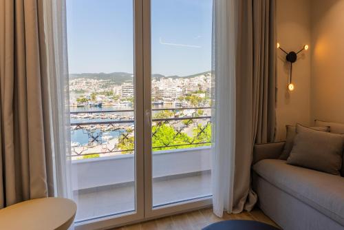 a living room with a large window with a view at Iridium Old Town Luxury Suites in Kavala