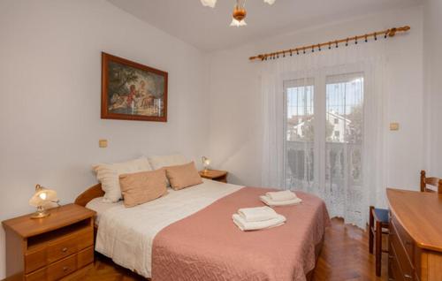 a bedroom with a bed with two towels on it at Apartment Sabina&Zoran in Malinska