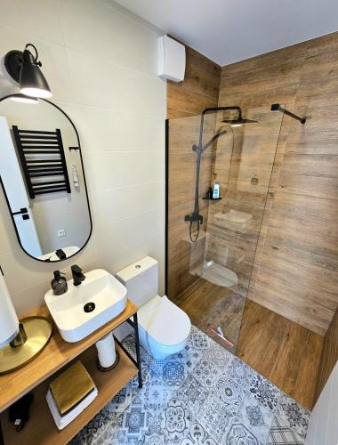 a bathroom with a sink and a shower at Binibona Barn Haven Rydzewo in Rydzewo
