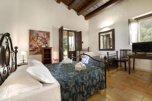 a bedroom with a bed with two teddy bears on it at Baglio donna Concetta in Noto