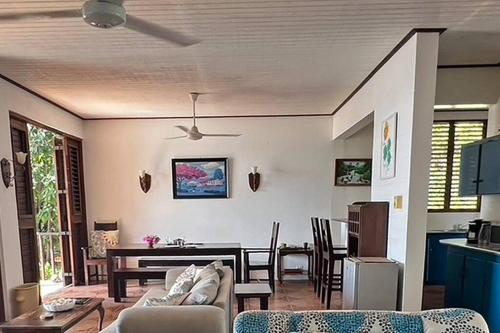 a living room with a couch and a table at Bliss By The Sea - Beach Front Villa with Private Pool in Treasure Beach