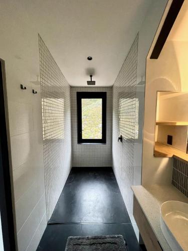 a bathroom with a walk in shower and a window at The Unbound - Escape the Ordinary in Romansrivier