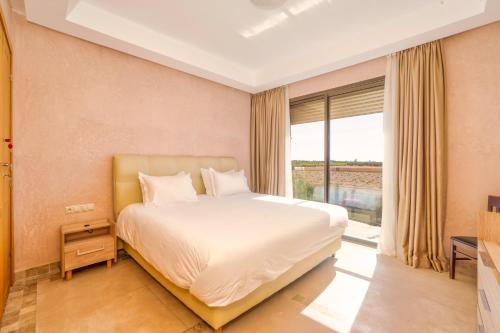 a bedroom with a bed and a large window at Summer Villa Peaceful Golf Haven in Marrakech