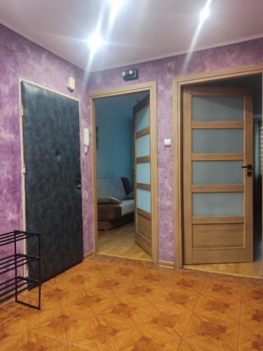 a room with two doors and a bed at Mieszkanie Jarosław Żeromskiego 10 in Jarosław
