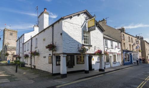 an old white building on the side of a street at Sun Inn in Kirkby Lonsdale
