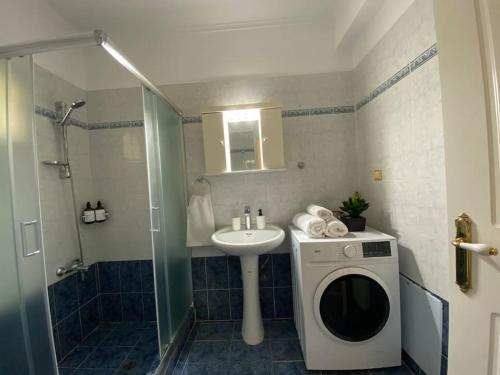 a bathroom with a washing machine and a sink at Mermaid apartment Nafplio in Nafplio