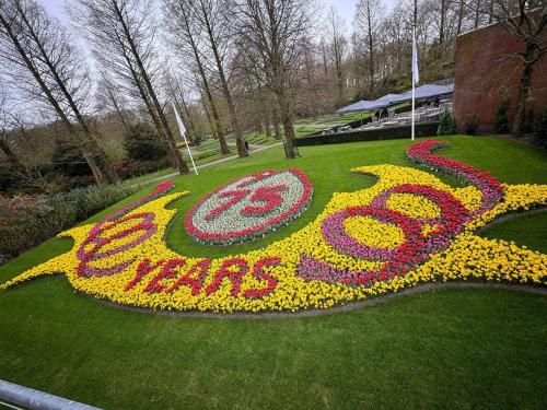 a peace sign made out of flowers in the grass at One bedroom apartement with terrace and wifi at Lisse in Lisse