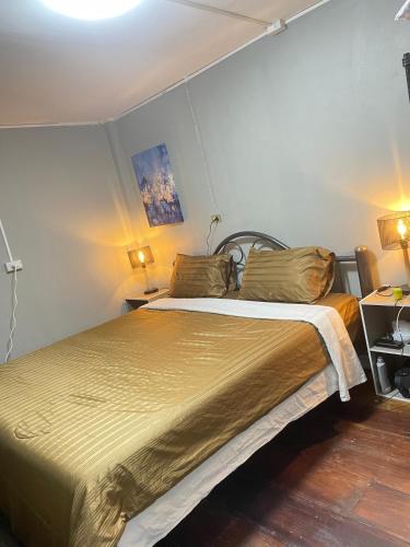 a bedroom with a large bed in a room at Udon House in Udon Thani