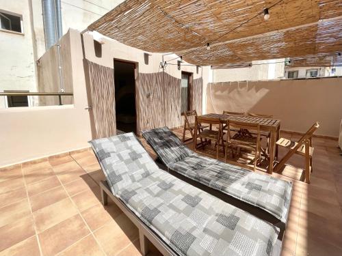 a room with a table and a table and chairs at Benidorm Old Town House with lounge area in Benidorm