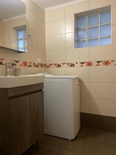 a kitchen with a sink and a white refrigerator at Sofokleous Apartment in Kavala