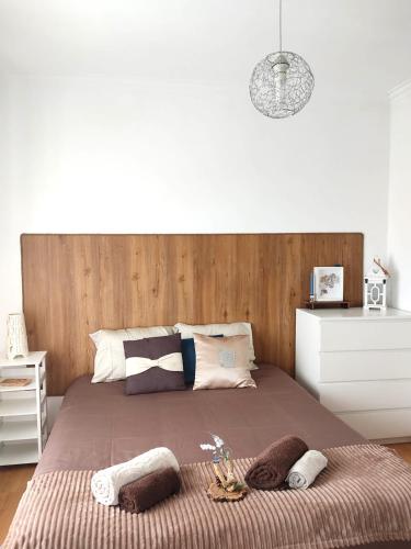 a bedroom with a large bed with a wooden headboard at Casa da Lameira in Serra