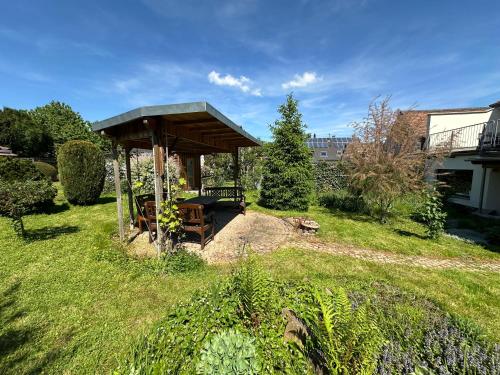 a wooden gazebo in a grassy yard at Pension Schramm in Karlsruhe