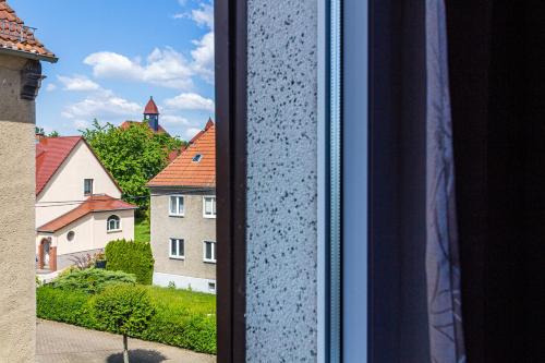 a view from a window of houses and a church at Monteurwohnung in Rötha in Rötha