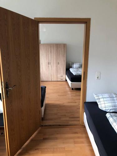 a room with two beds and a door to a bedroom at Monteurwohnung in Rötha in Rötha