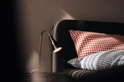 a lamp sitting next to a pillow next to a couch at Heimathafen in Büsum