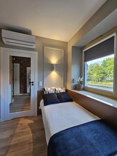a bedroom with a large bed and a window at Villa Evmerol in Wrocław