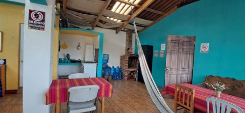 a dining room and kitchen with a table and chairs at Hostal Dulces Sueños in Panajachel