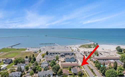 an aerial view of a beach with a red arrow at Ludington Pier House in Ludington