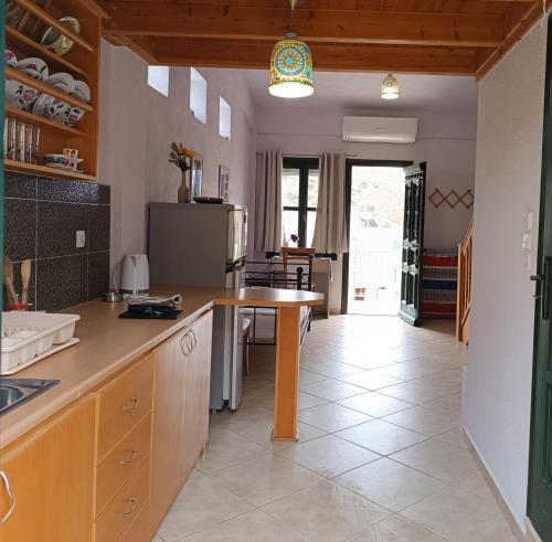 a kitchen with a counter and a table in it at Seaside Apartments 1 in Emborios Kalymnos