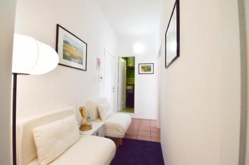 a living room with two white couches and a lamp at Casa Ekaterina free wifii - spiaggia 200 metri in Brolo