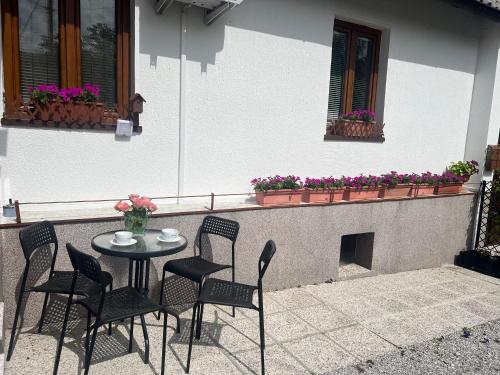 a patio with a table and chairs and a fireplace at Apartma Lozar in Ajdovščina