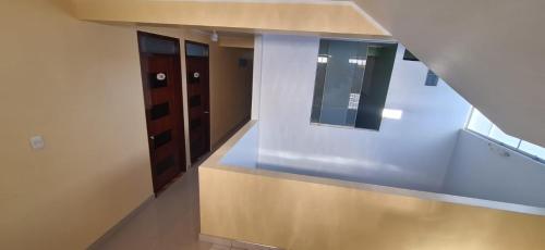an empty room with a staircase with wooden cabinets at HOSPEDAJE EL CANTARO II in Tingo María