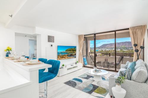 a living room with a couch and a table at Newly Renovated 2 Bedroom Condo, 1 Block to Waikiki Beach, Free Parking in Honolulu