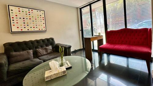 a living room with a couch and a table at Suites Lerma 205 in Mexico City