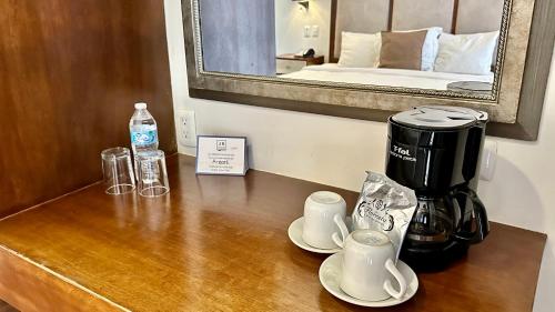 a coffee maker and cups on a counter in a hotel room at Suites Lerma 205 in Mexico City