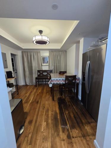 a living room with a table and a refrigerator at Beautiful Boston Bedroom - New Renovation in Boston