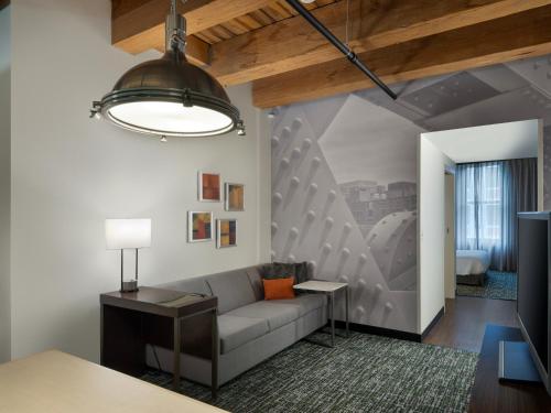 a living room with a couch and a lamp at Residence Inn by Marriott Boston Downtown Seaport in Boston
