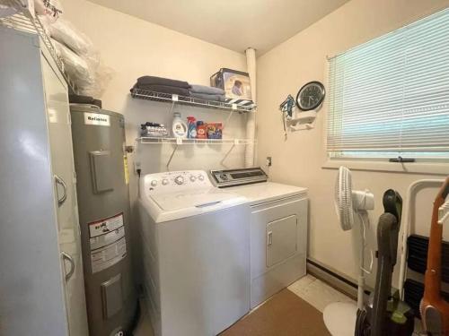 a small kitchen with a stove and a washer at Hunter Mountain Slope Side Home in Lanesville