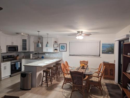 a kitchen with a table and chairs in it at La Boca Beach House in Englewood