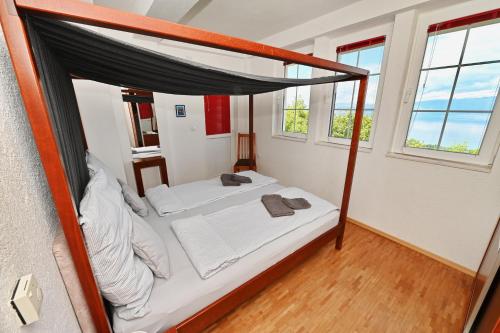 a bedroom with a bed with a canopy at Villa Velestovo in Ohrid