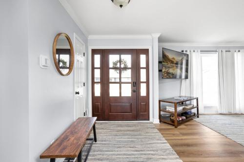a hallway with a wooden bench and a mirror at Hometown Hideaway - 4br25ba, Pool, Game Room in Greenwood