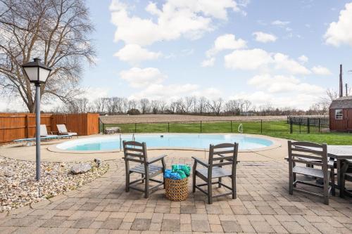 a patio with two chairs and a swimming pool at Hometown Hideaway - 4br25ba, Pool, Game Room in Greenwood