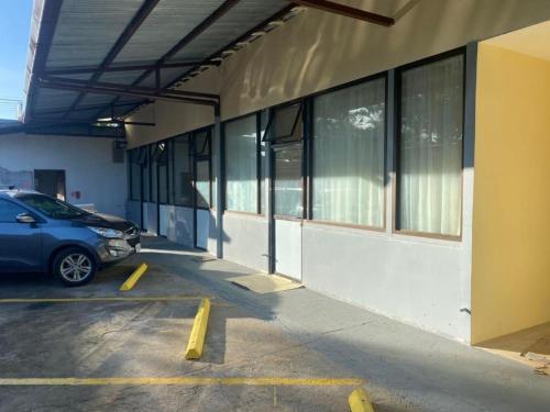 a car parked in a parking lot next to a building at Villa Garita Inn in La Garita