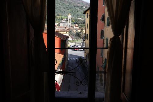 a view from an open window of a city at Mansarda Pescia in Pescia