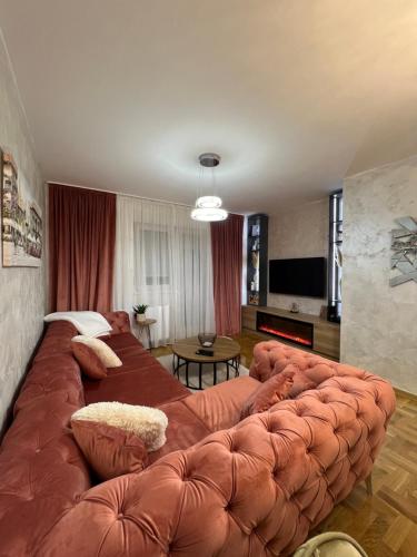 a large brown couch in a living room at Stan na dan,Beograd -Žarkovo in Bele Vode