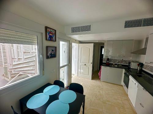 a kitchen with a table and chairs in a room at Apartamento DESA Laguna Beach Vera Playa in Vera