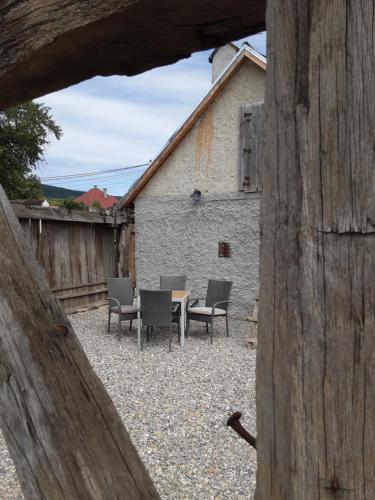 um grupo de cadeiras e uma mesa num quintal em Casa Via Viscri em Buneşti
