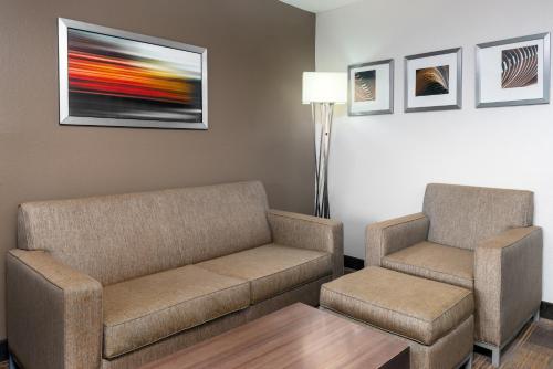a waiting room with a couch and two chairs at Holiday Inn Miami-Doral Area by IHG in Miami