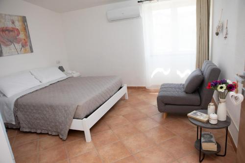 - une chambre avec un lit, un canapé et une chaise dans l'établissement Su Hantaru Vetzu, à Mamoiada