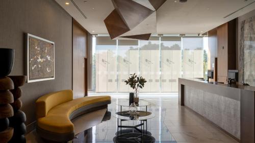 a living room with a couch and a table at Sheraton Guadalajara Expo in Guadalajara