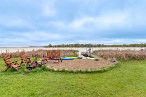 two chairs and a picnic table in the grass at Away at Moose Bay Breezy Point Gem with Game Room in Breezy Point