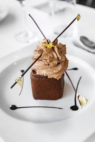 a piece of cake on a white plate on a table at Du Côté Des Olivades in Paradou