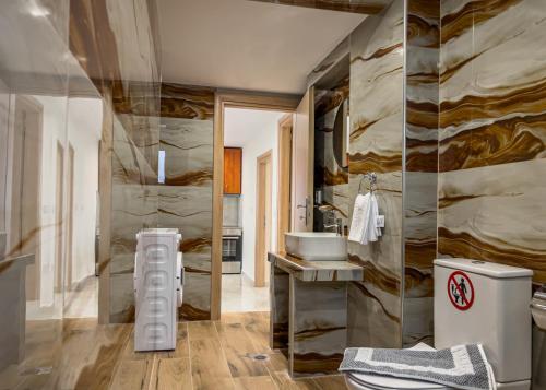 a bathroom with a toilet and a sink at Loridis Central Apartments in Prinos