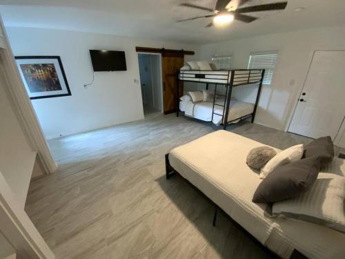 a bedroom with a bed and a bunk bed at The Lilliane in Stephenville