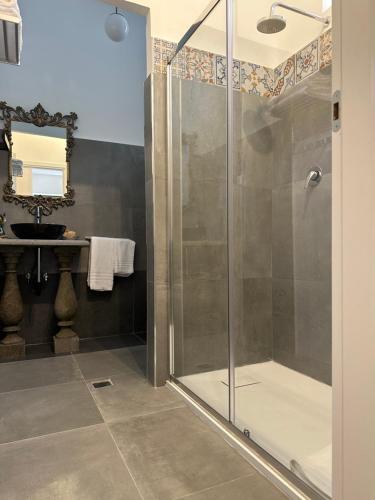 a glass shower in a bathroom with a sink at Palazzo Dasso in Viterbo