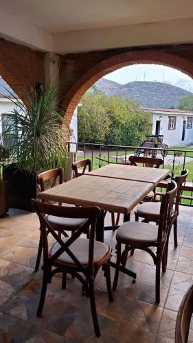 a wooden table and chairs on a patio at El Monasterio in San Joaquín